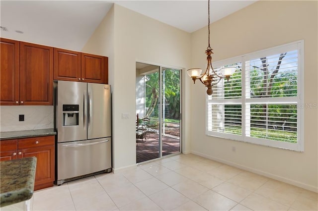 kitchen featuring light tile patterned flooring, stainless steel fridge with ice dispenser, tasteful backsplash, an inviting chandelier, and pendant lighting