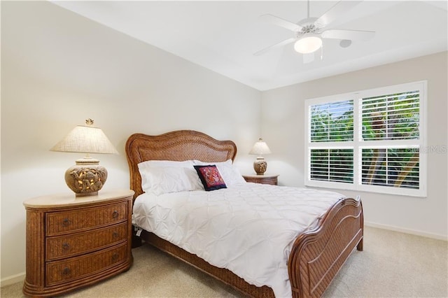 carpeted bedroom featuring a ceiling fan and baseboards