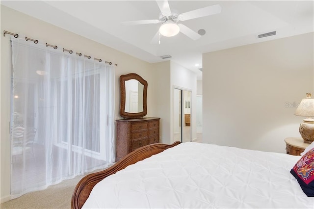 carpeted bedroom featuring a ceiling fan, a closet, and visible vents