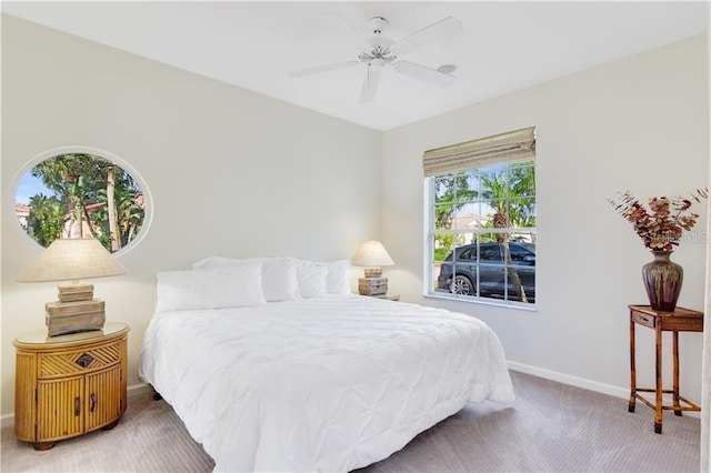 carpeted bedroom with a ceiling fan and baseboards