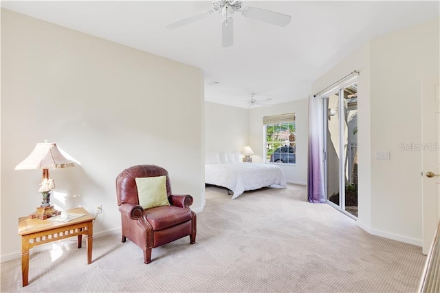 carpeted bedroom with ceiling fan and baseboards