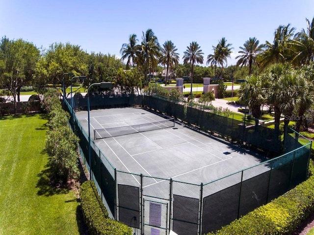 view of sport court with a yard, fence, and a gate