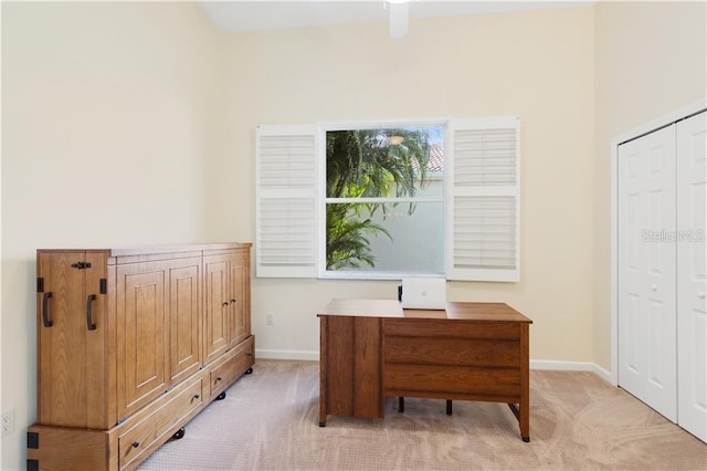 office space featuring light carpet and baseboards