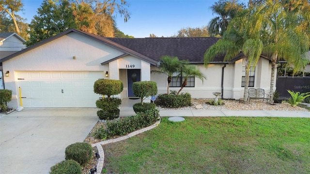 single story home featuring stucco siding, a shingled roof, a front yard, a garage, and driveway