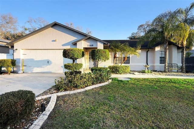 view of front facade with a garage, a front lawn, concrete driveway, and stucco siding