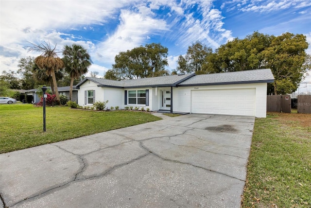 single story home featuring driveway, an attached garage, fence, and a front yard