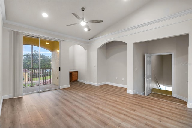 empty room featuring lofted ceiling, ceiling fan, light wood finished floors, and baseboards