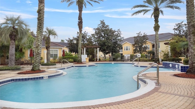 pool with fence and a patio