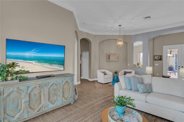 living room with arched walkways, visible vents, an inviting chandelier, ornamental molding, and tile patterned flooring