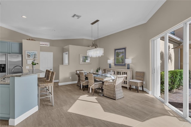 dining area with light tile patterned floors, ornamental molding, visible vents, and baseboards