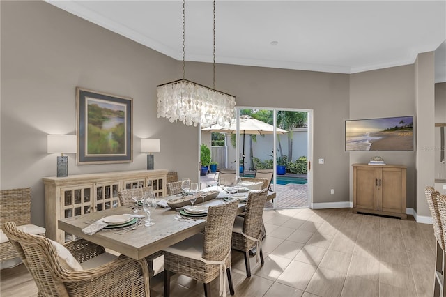 dining space with baseboards, light tile patterned floors, an inviting chandelier, and crown molding