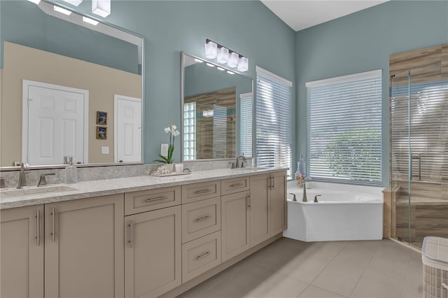 bathroom with tile patterned flooring, a sink, a shower stall, a bath, and double vanity