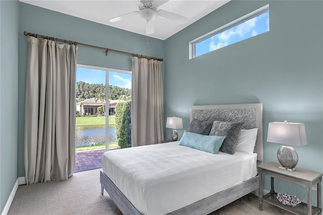 bedroom with carpet floors, a water view, a ceiling fan, access to outside, and baseboards