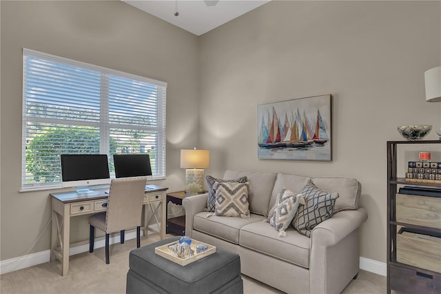 living room featuring light carpet and baseboards