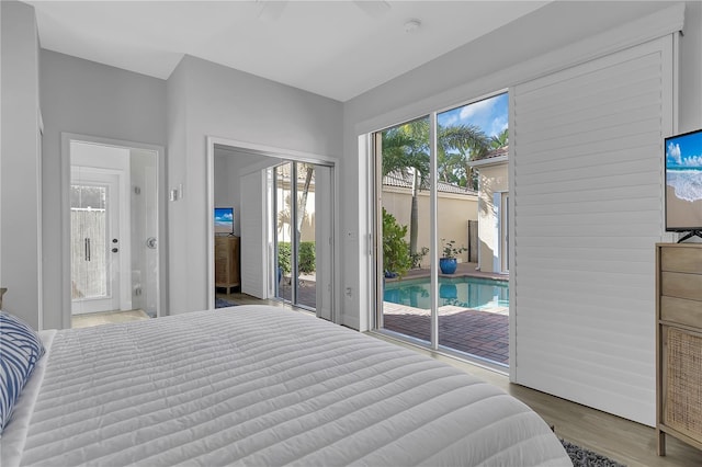 bedroom featuring access to exterior and wood finished floors