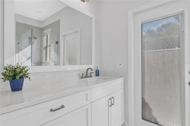 full bathroom featuring a stall shower and vanity