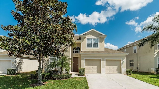 view of front of property featuring driveway, a front yard, a garage, and stucco siding