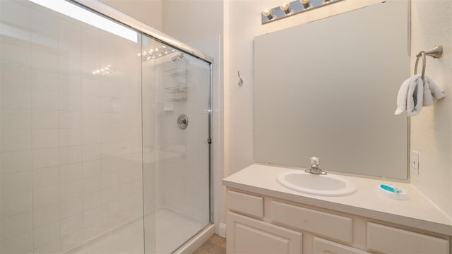 bathroom featuring a shower stall and vanity