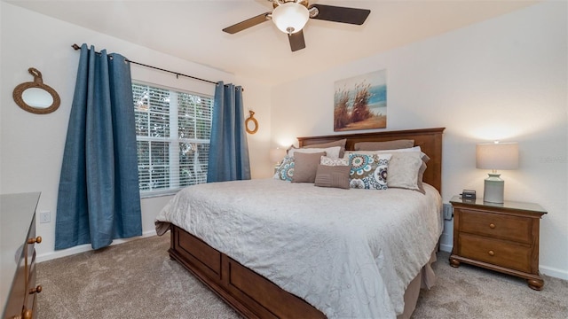 bedroom with baseboards, a ceiling fan, and light colored carpet