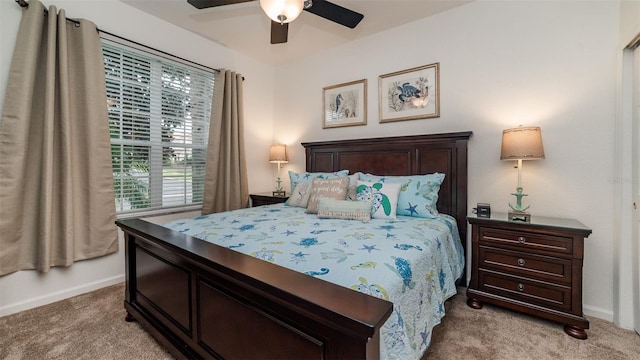 bedroom featuring light carpet, baseboards, and a ceiling fan