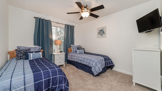 carpeted bedroom featuring ceiling fan and baseboards