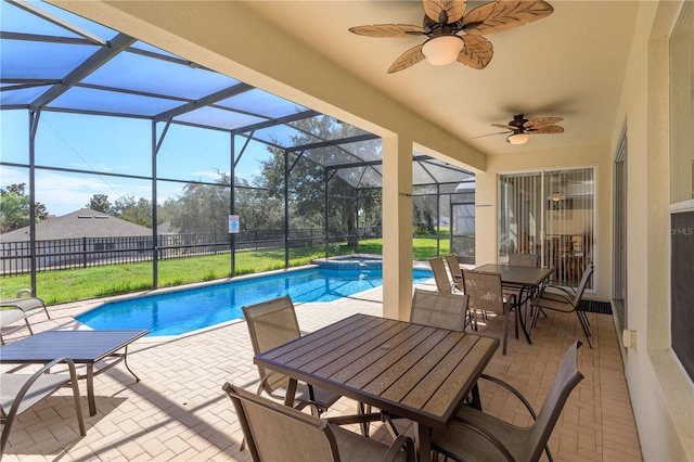 view of swimming pool with a patio, glass enclosure, fence, outdoor dining area, and a pool with connected hot tub