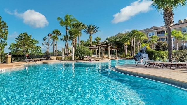 community pool featuring a patio area, fence, and a pergola