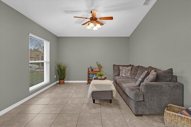 living room with visible vents, ceiling fan, baseboards, and light tile patterned floors