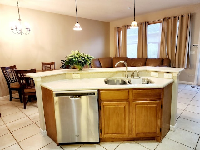 kitchen featuring a sink, a kitchen island with sink, light countertops, and dishwasher