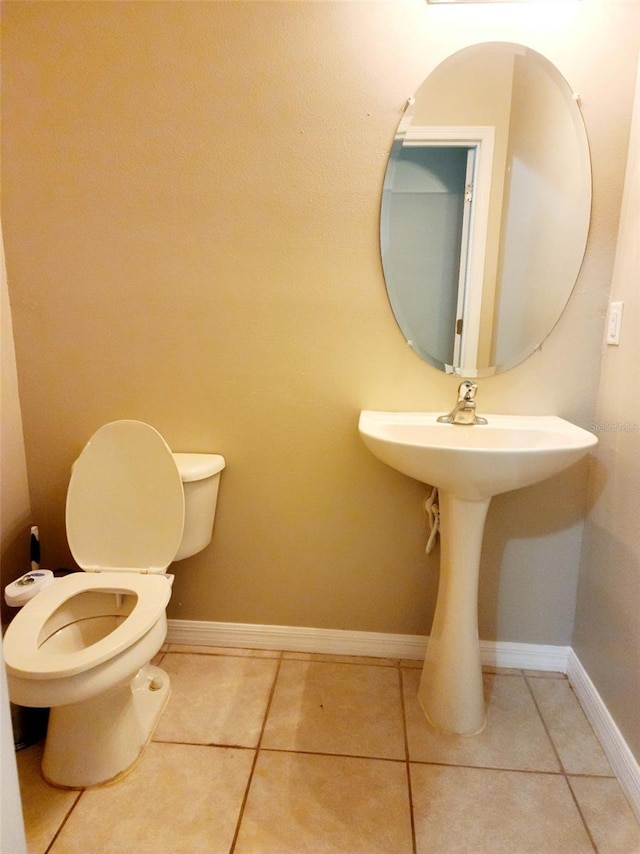 bathroom featuring baseboards, toilet, and tile patterned floors