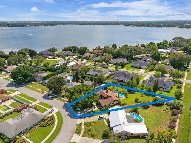 drone / aerial view featuring a water view and a residential view