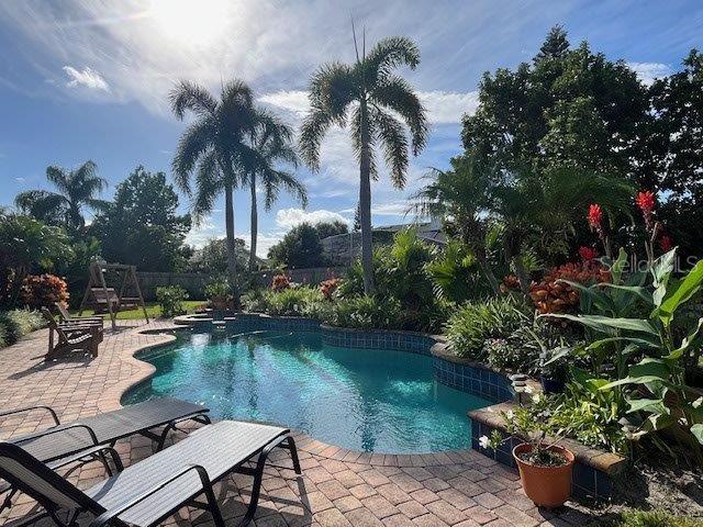 view of swimming pool featuring fence, a fenced in pool, and a patio