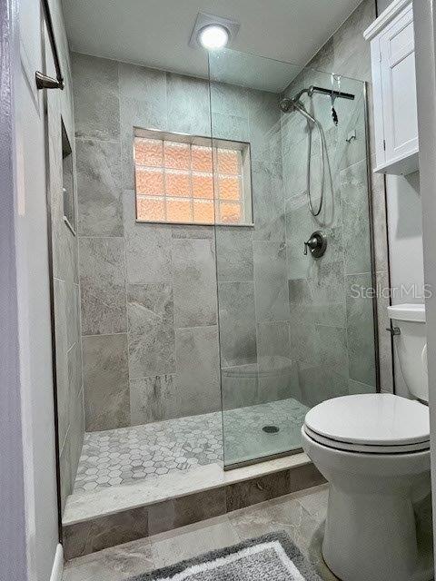 bathroom featuring toilet and walk in shower