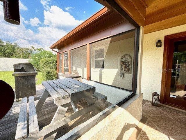 deck with a sunroom