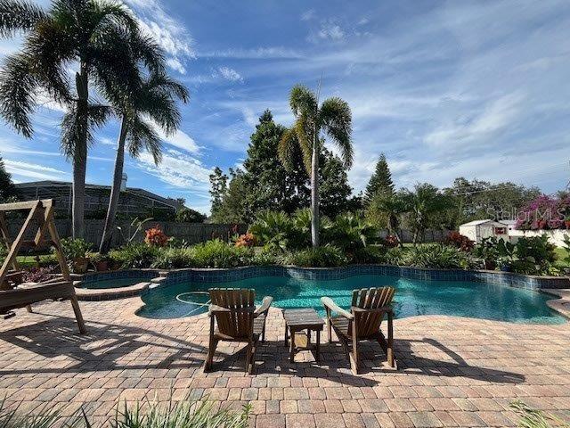 view of swimming pool featuring a patio area and a pool with connected hot tub