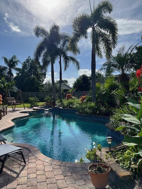 view of pool with a fenced in pool, a fenced backyard, and a patio