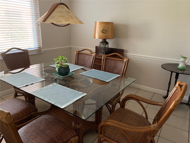 dining space featuring baseboards and tile patterned floors