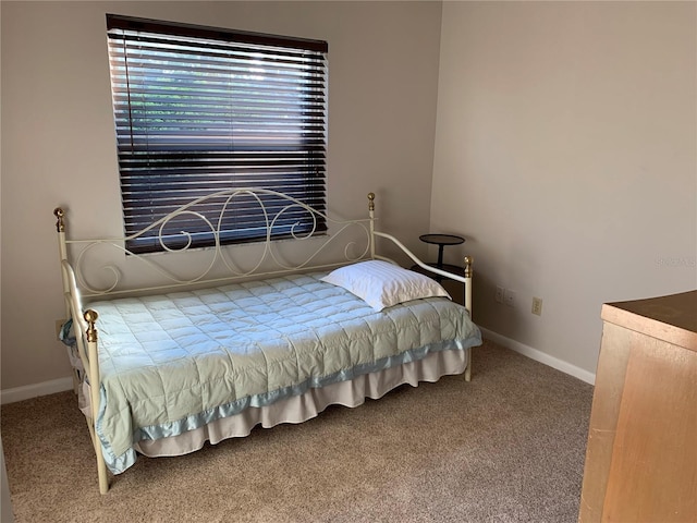 carpeted bedroom with baseboards