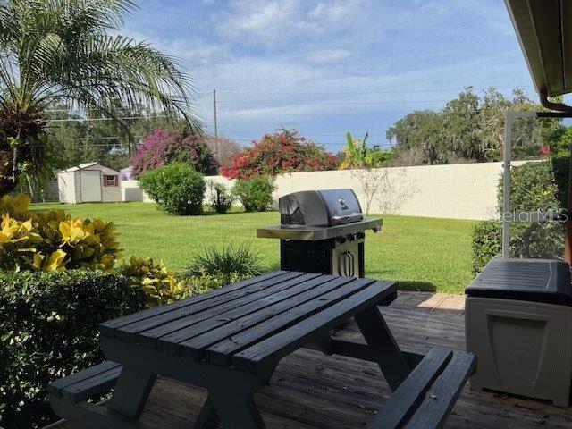 exterior space with outdoor dining space, an outdoor structure, fence, and a shed