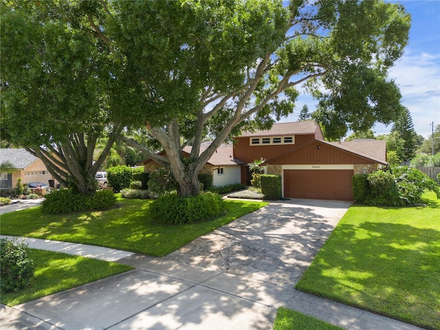 view of front of property featuring a garage, stone siding, concrete driveway, and a front yard