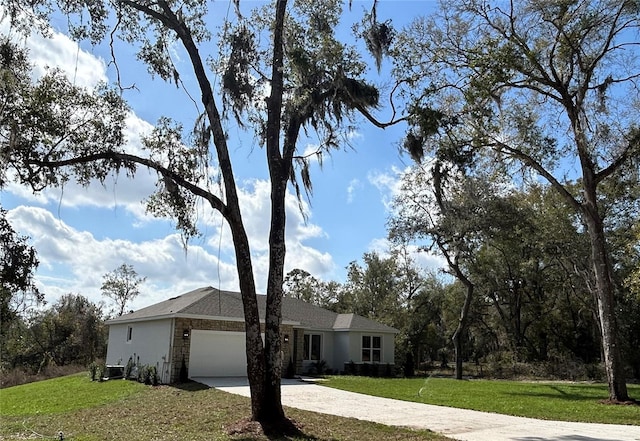 ranch-style home featuring driveway, a garage, and a front yard