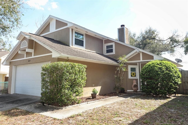 view of front of home featuring a chimney, a shingled roof, an attached garage, fence, and driveway