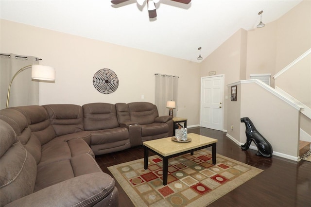 living area featuring baseboards, a ceiling fan, wood finished floors, stairs, and high vaulted ceiling