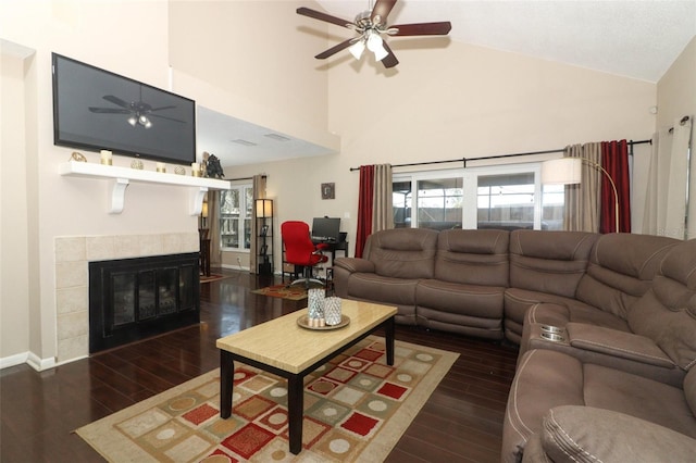 living room featuring a fireplace, wood finished floors, a ceiling fan, and baseboards