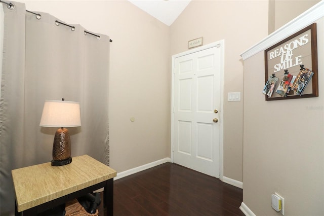 entrance foyer with baseboards, vaulted ceiling, and dark wood-style flooring