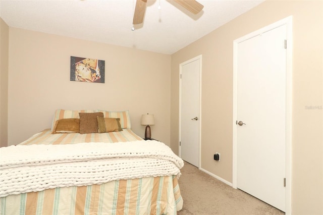 bedroom with light carpet and ceiling fan