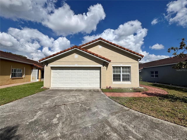 view of front of home featuring a garage, concrete driveway, stucco siding, a tiled roof, and a front yard