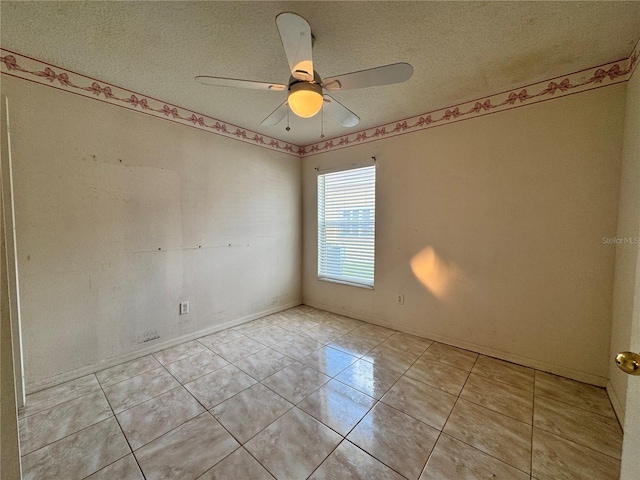 unfurnished room featuring a ceiling fan, a textured ceiling, and light tile patterned floors