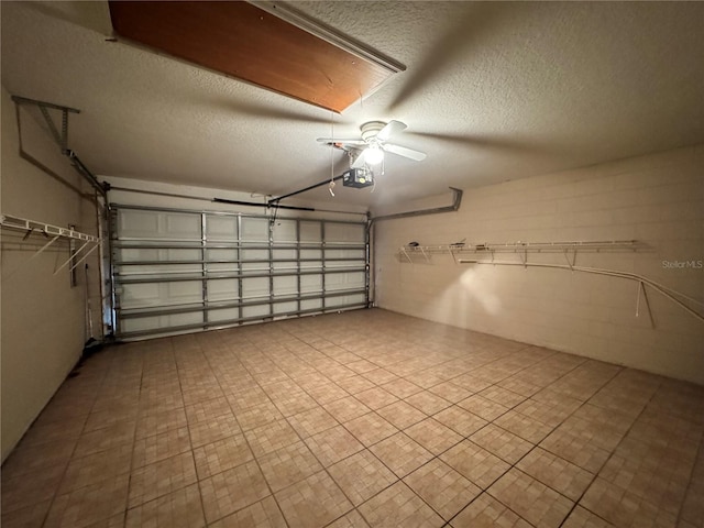 garage featuring concrete block wall and a garage door opener