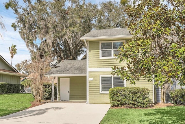 view of front of property with a front lawn and roof with shingles